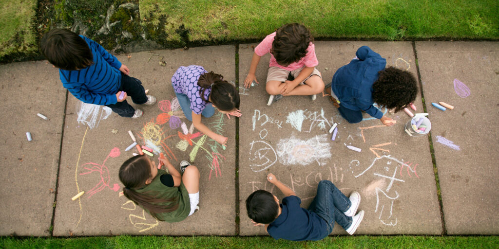 National Good Neighbor Day Featured Image - Kids walk chalk on sidewalk Healthy Community Setting